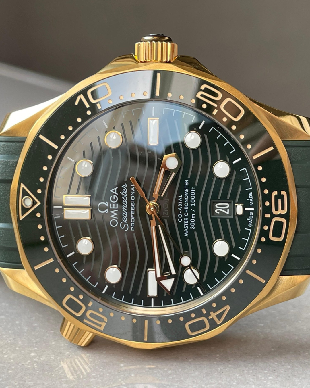 Seamaster Diver 300mm watch with green dial and gold case close-up