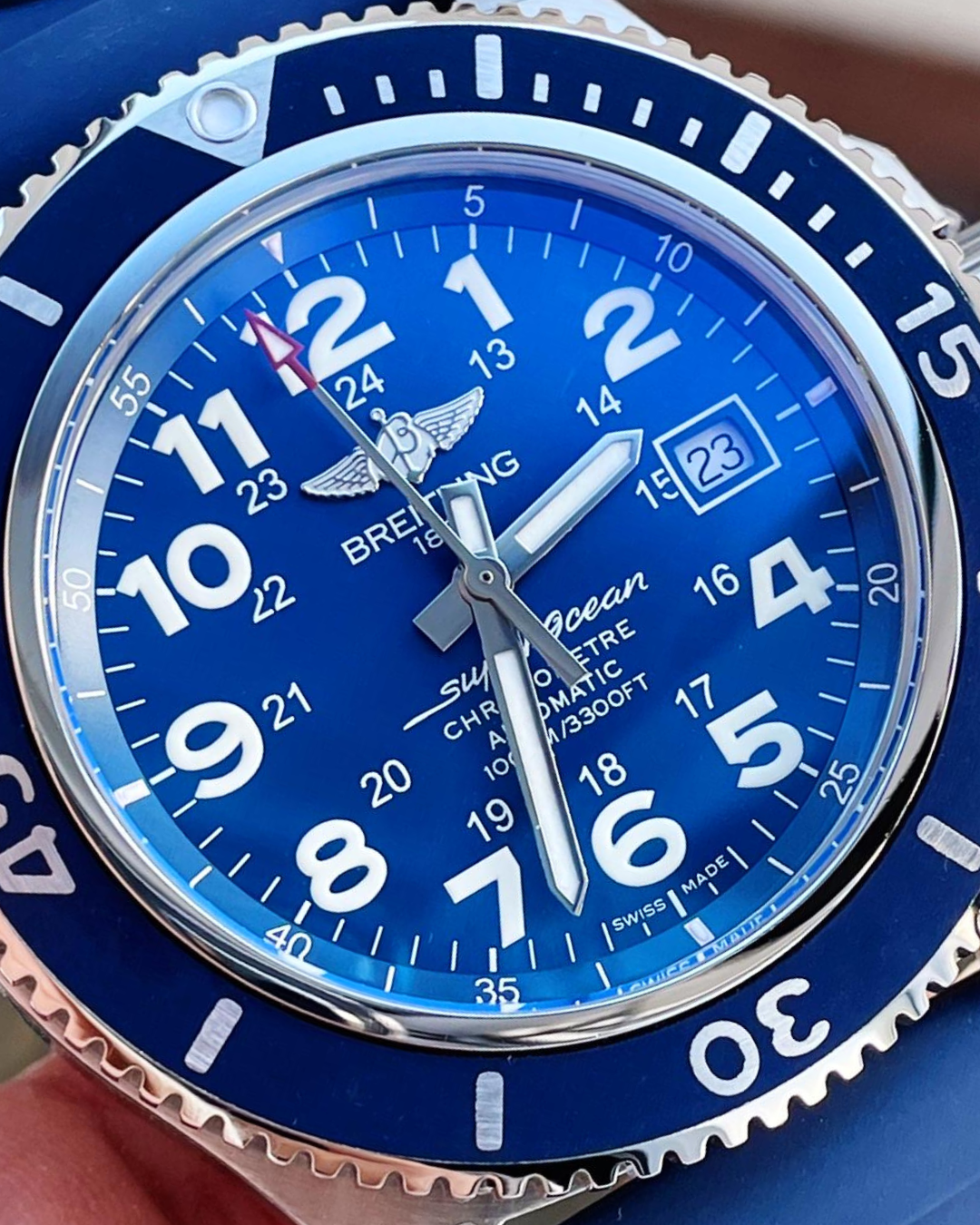 Breitling Superocean Super Watch with blue dial, stainless steel case, and silicone bracelet