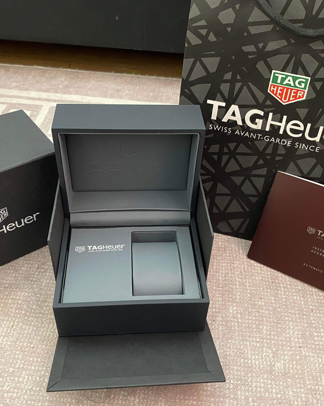 Heuer Watch Box open branded watch storage with Tag Heuer packaging and booklet