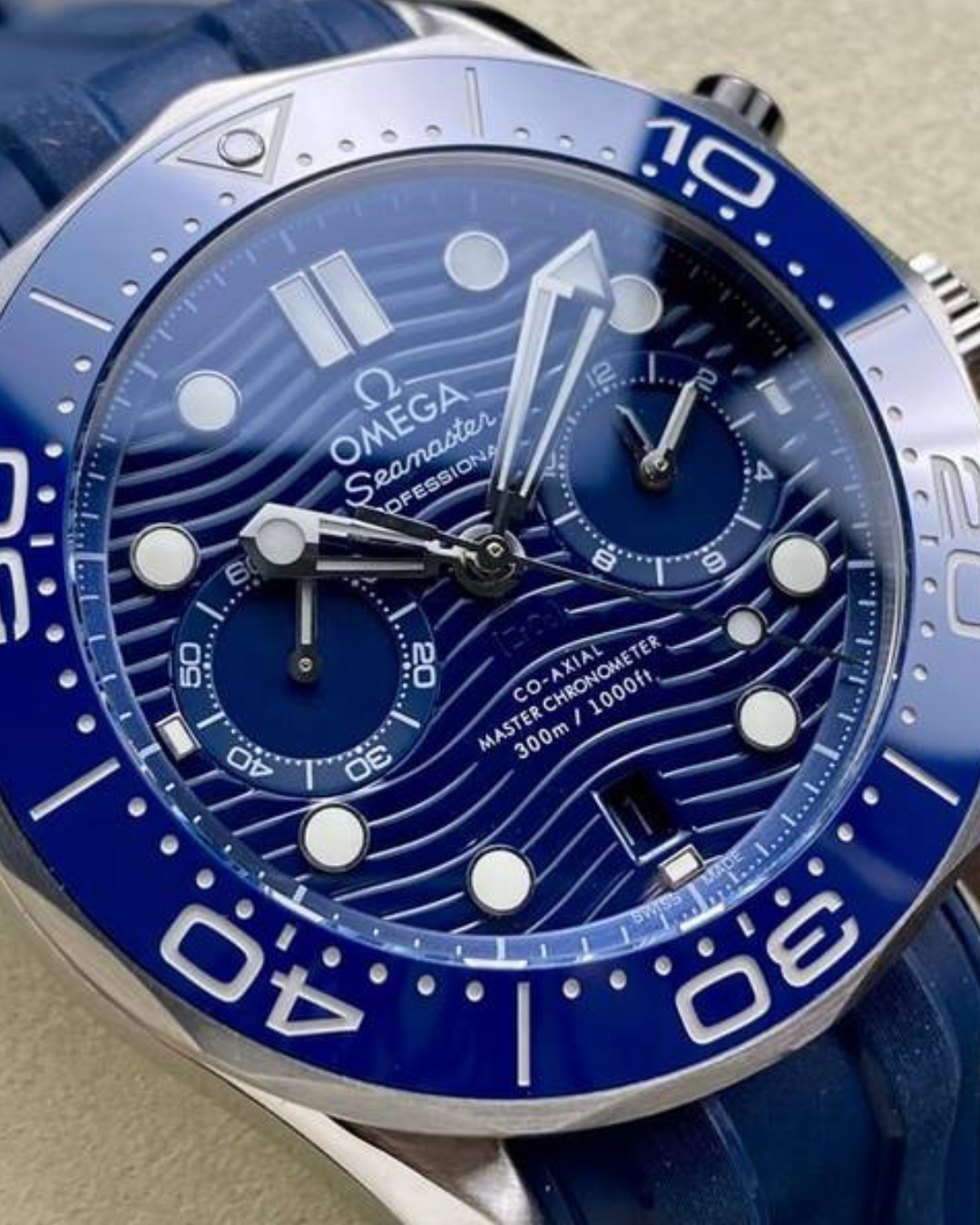 Omega Seamaster 44mm Diver 300m watch with blue ceramic dial, rubber strap, and chronograph sub-dials.