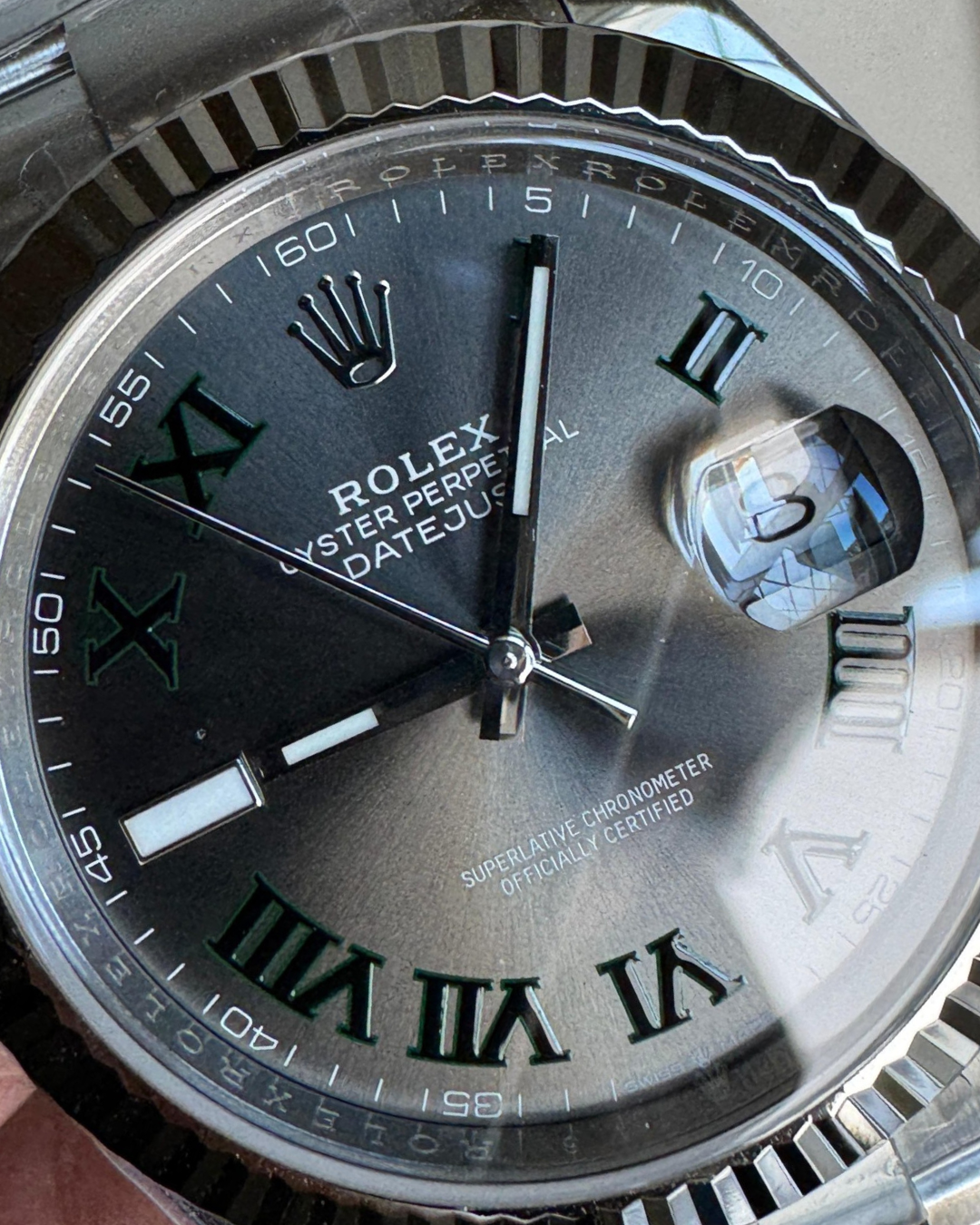 Close-up of Date-just Wimbledon 41mm watch face with Roman numerals and magnified date display