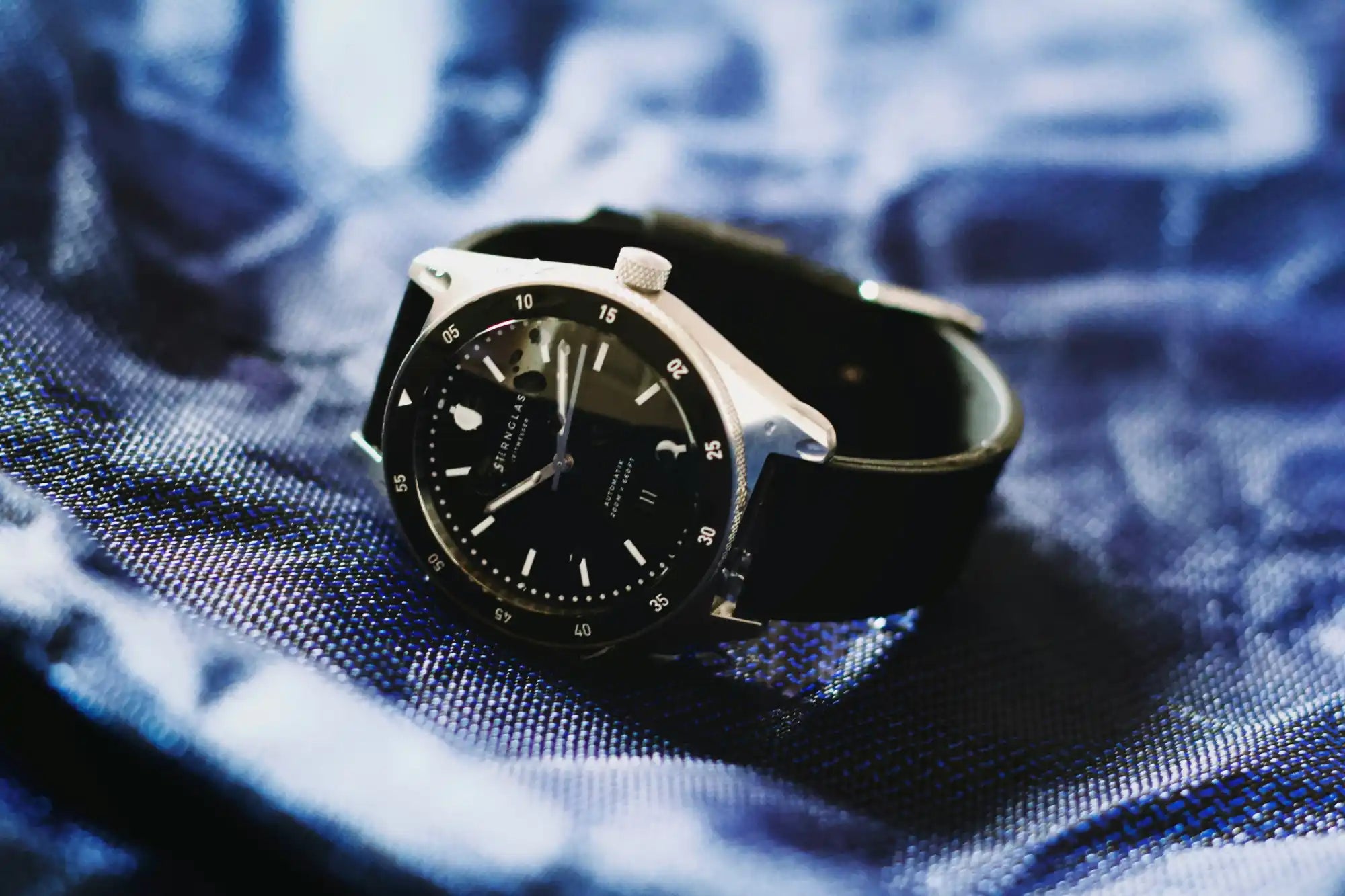 Silver wristwatch with black band and face.